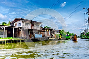 Wooden houses on stilts on the riverside of Chao Praya River, Bangkok, Thailand