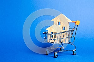 Wooden houses in a trading cart. The concept of buying a house or apartment. Affordable housing. Profitable and cheap loans