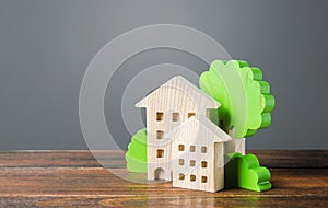 Wooden houses and trees. Affordable comfortable housing. Purchase of apartments and real estate, rent and sale. Housing, new home photo