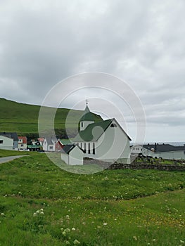 Wooden houses and white church on Mykines, Faroe Islands
