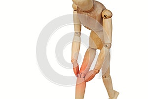 Wooden human with knee pain.