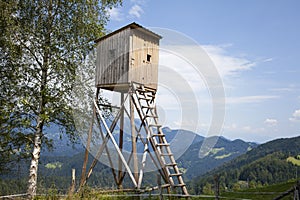 Wooden hunters high tower. Hunters high seat.