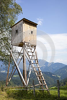 Wooden hunters high tower. Hunters high seat.