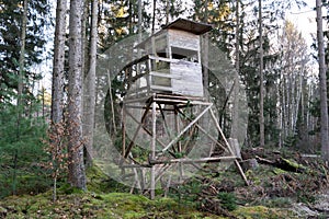 Wooden hunters perch in the forest