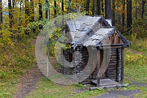 Wooden hut in the autumn forest