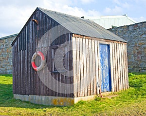 Wooden hut with blue door.