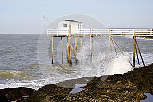 Wooden hut fisherman in atlantic coast wave in talmont sur Gironde France