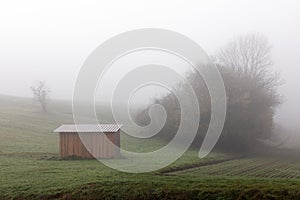 Wooden hut in fog