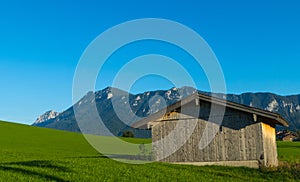 Wooden Hut in front of alpine mountain range Alps Bavaria