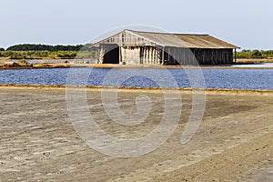 Wooden hut with ground and sea water in evaporation; ponds at Ph