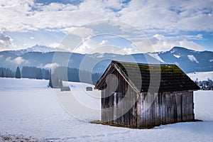 Wooden hut near Bad Mitterndorf with mountain Kammspitz in winter