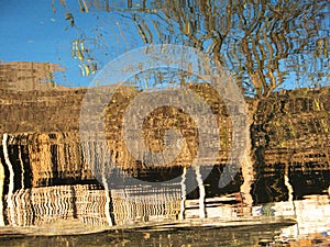 Wooden hut reflected in the waters of Inle Lake