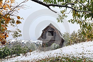 Wooden hut and a snowstorm in the mountains