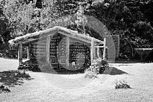 Wooden hut with wooden chairs under the straw roof in the countryside Madeira, Portugal