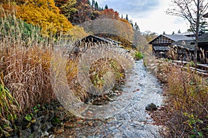 Wooden huts among the forrest in autumn, Tsuru-no-yu Onsen - Senboku, Akita, Japan