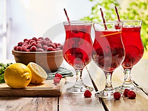 On wooden is ice cold beverage glass with berries cocktail .