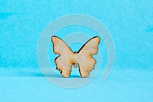 Wooden icon of butterfly on blue background