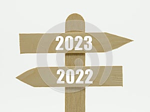 Wooden indicator sign with the year 2023 and 2022 photo