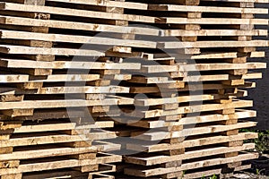 Wooden industrial coasters stacked for storage, selective focus