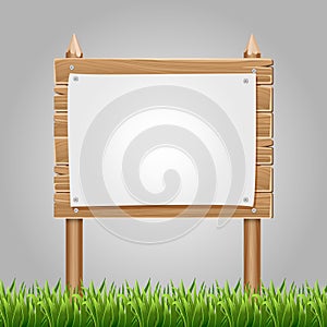 Wooden information blank with green grass