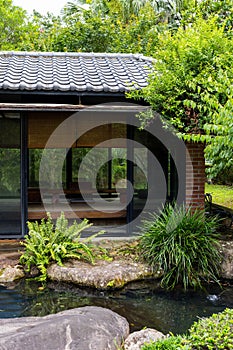 Wooden Japanese house garden with water pond