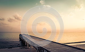 Wooden jetty and amazing sunrise in Maldives