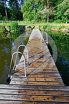 wooden jetty with bathing ladder in early morning