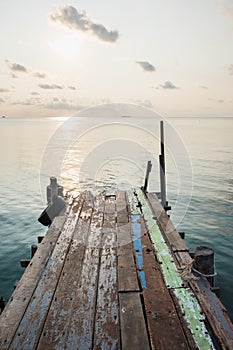 Wooden jetty bridge with seascape during sunrise