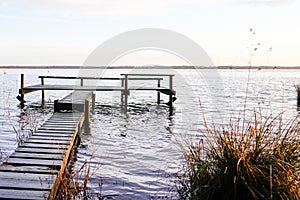 Wooden jetty fishing boat on lake of sanguinet biscarosse in landes france