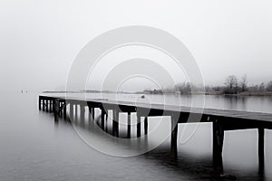 Wooden jetty in the grey photo