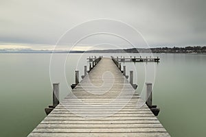Wooden jetty at lake Starnberger See, Bavaria, Germany, in winter