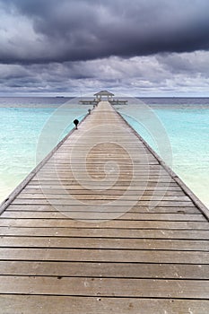 Wooden jetty over the beautiful Maldivian ocean