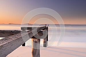 Wooden jetty ruins on an idyllic beach in Esperance, Australia