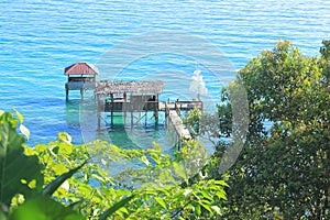 Wooden jetty and shacks on sea