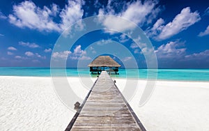 Wooden jetty to a water lodge on a tropical beach