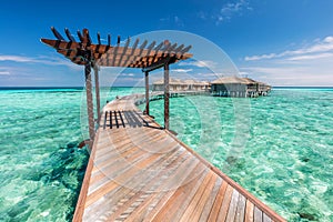 Wooden jetty towards water villas in Maldives.