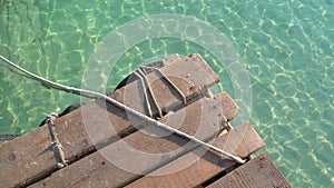 Wooden jetty in the turquoise clear sea water
