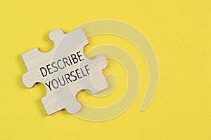 Wooden jigsaw puzzle with phrase DESCRIBE YOURSELF