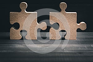 Wooden jigsaw puzzle on wood table background. Business solving , Teamwork and partnership concept