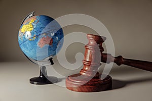 Wooden Judge gavel and globe. International law and justice court concept