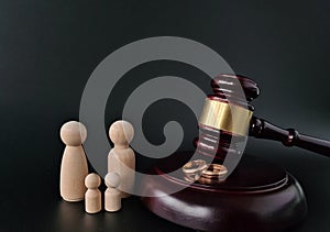 Wooden judge gavel and gold rings divorce concept