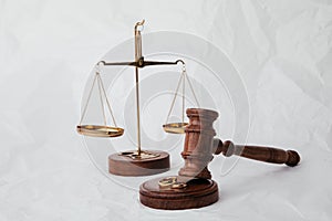 Wooden judge gavel with rings on light background. Family, divorce and law concept