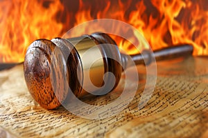 Wooden Judge Gavel on a Sounding Block with Fiery Background Symbolizing Hot Legal Issues