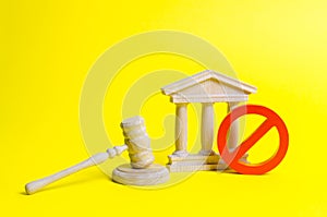 Wooden judge hammer and government building on a yellow background. Court. Concept of the state judicial system