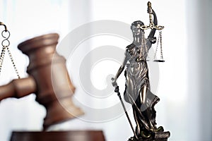 Wooden judge`s gavel. Themis figurine The criminal law.