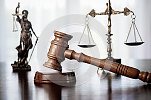 Wooden judge`s gavel. Themis figurine The criminal law.