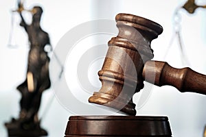 Wooden judge`s gavel. Themis figurine The criminal law.