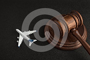 Wooden judges gavel and toy plane. Aviation Law. Lawsuit with the airline