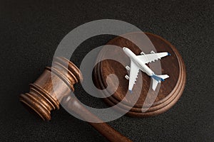 Wooden Judges gavel and toy plane. Aviation Law. To sue the airline