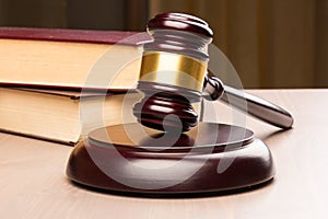 Wooden judges gavel on wooden table, close up. Space for text